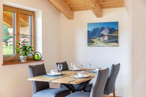 a dining room with a wooden table and chairs at Haus Stoabock in Wallgau