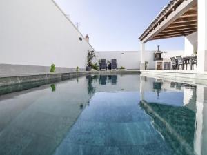 a swimming pool with blue water in a house at Casa Regalo in Dúrcal
