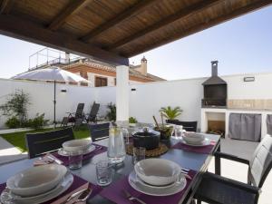 a table with plates and glasses on a patio at Casa Regalo in Dúrcal