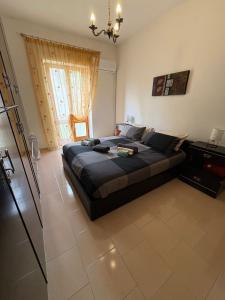 a bedroom with a large bed and a large window at La casa di nonna Gianna in Gonnesa