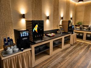 a kitchen with a counter with a coffee machine at Vitosha Park Hotel - Free Pool & Gym in Sofia