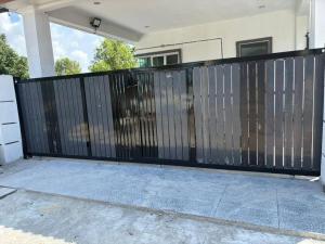 a black fence in front of a house at Legacy Yumai in Kuala Rompin