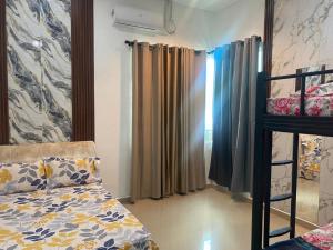 a bedroom with a bed and a bunk bed at Legacy Yumai in Kuala Rompin