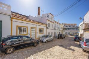 a group of cars parked in a street at Lanzarote Villa in Alvor
