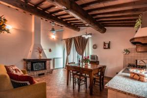 a kitchen and living room with a table and a fireplace at Agriturismo Spazzavento in Vinci