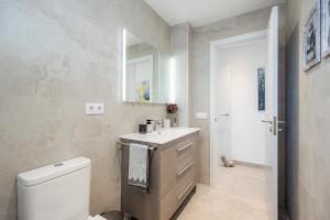 a bathroom with a white toilet and a sink at Apartamento Lliteras 2C Ref 9003 in Cala Millor +16 photos
