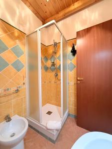 a bathroom with a shower and a toilet and a sink at Casa Cinema Paradiso in Cefalù