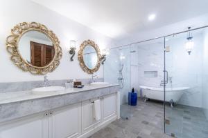 a bathroom with two sinks and a tub and a mirror at Rimwiang in Chiang Mai +58 photos
