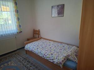 a small bed in a bedroom with a picture on the wall at Ferienwohnung Anneliese in Obdach
