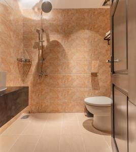 a bathroom with a toilet and a shower at Jolia Nha Trang Hotel in Nha Trang +67 photos