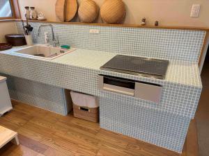 a kitchen with a blue tile counter with a sink at Cyokiya Lake Saiko in Fujikawaguchiko +44 photos