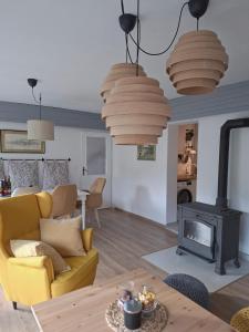 a living room with a yellow couch and a fireplace at Villa Arboreta in Tuhelj