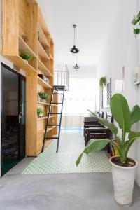 a room with a staircase and a plant at OHA Homestay in Quy Nhon