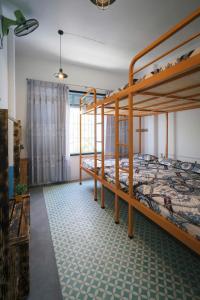 a bedroom with two bunk beds and a window at OHA Homestay in Quy Nhon