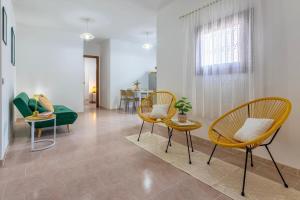 a living room with two chairs and a table at Appartamenti Da Ewa Valledoria in Valledoria