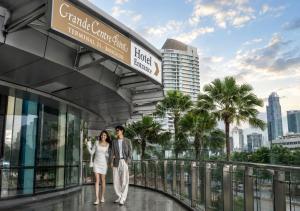 a couple standing in front of a building at Grande Centre Point Hotel Terminal21 in Bangkok +65 photos