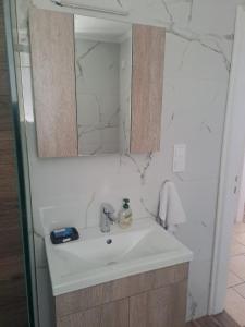 a bathroom with a sink and a mirror at Aspasia's apartment in Mytilene +12 photos