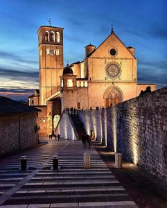 a large building with a clock tower in front of it at Casa Umbria in Gubbio