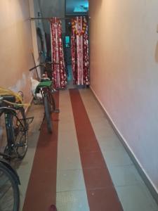 a hallway with bikes parked in a room at Radhe house in Gwalior