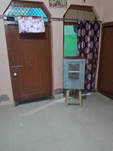 a room with a door and a fan in front of a door at Radhe house in Gwalior