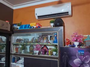 a room with a display cabinet with christmas decorations at Radhe house in Gwalior