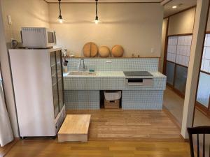 a kitchen with a refrigerator and a sink at Cyokiya Lake Saiko in Fujikawaguchiko