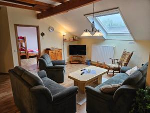 a living room with couches and a table at Ferienhof van Vlyten_ 45006 in Jemgum