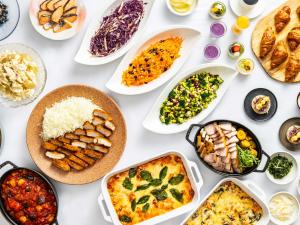 a table full of different dishes of food at Hotel Elcient Kyoto Hachijoguchi in Kyoto