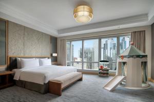 a bedroom with a bed and a large window at Kerry Hotel, Beijing by Shangri-La in Beijing