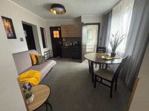 a living room with a couch and a table at 208 Apartment Ania in Koszalin