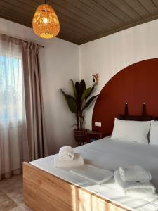 a bedroom with a large bed with towels on it at Skapin house in Skopelos Town