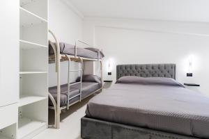a bedroom with two bunk beds and a mirror at Marechiaro Aparthotel in Marina di Camerota