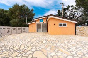 a house with a driveway in front of it at Marechiaro Aparthotel in Marina di Camerota