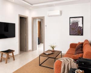 a living room with a couch and a table at Oikos Apartments in Haraki