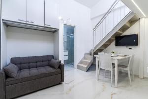 a living room with a couch and a table at Marechiaro Aparthotel in Marina di Camerota