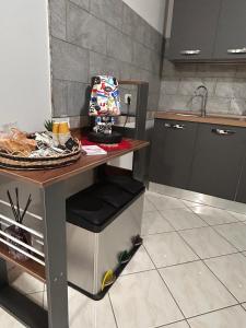 a kitchen with a table and a counter with a sink at Incanto Stabiese in Castellammare di Stabia +6 photos