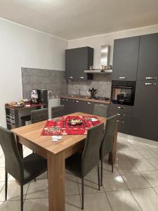 a kitchen with a wooden table and chairs in a room at Incanto Stabiese in Castellammare di Stabia
