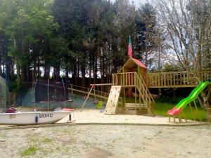 a playground with a boat and a slide at Yourte avec bain nordique in Quimper