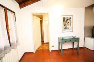a hallway with a blue table in a room at Guest House Rossana in Reggio Emilia
