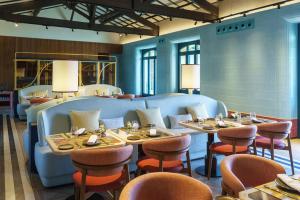 a restaurant with tables and chairs in a room at Áurea Palacio de la Tinta by Eurostars Hotel Company in Málaga