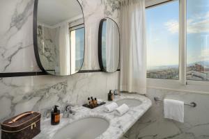 a bathroom with two sinks and a large mirror at Hotel President in Viareggio +67 photos
