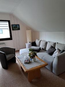 a living room with a couch and a coffee table at Ferienhof Augustenruh in Augustenruh
