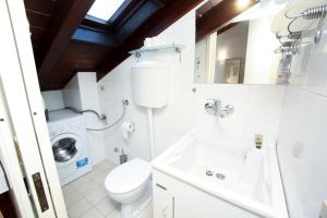 a bathroom with a toilet sink and a washing machine at Guest House Rossana in Reggio Emilia