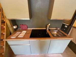 a small kitchen with a sink and a stove at Glamping Camping Rivabella in Lecco