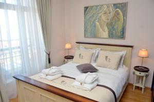 a bedroom with a bed with a painting on the wall at Thracian Cliffs Owners Apartments in Kavarna +26 photos