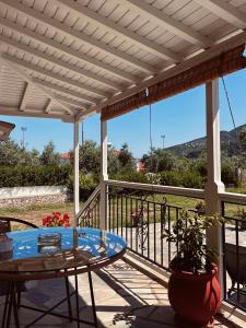 a patio with a table and a balcony with a view at Skapin house in Skopelos Town