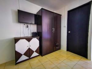 a room with a wooden cabinet and a door at Patong Canal Villa 308 in Patong Beach