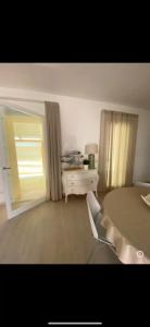 a bedroom with a bed and a table and a window at Stella di Mare with Jacuzzi, Costa Smeralda in Arzachena +8 photos