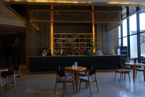 a restaurant with tables and chairs and a bar at Arena Oceanview Cam Ranh - Infinity swimming pool in Cam Ranh International Airport