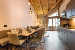 a dining room with a long table and chairs at Das Krumerhaus in Aschau
